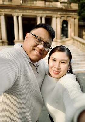 A close portrait of the two of them, smiling, arms around each other.